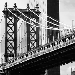 A steel suspension bridge extends diagonally across the frame, with a taller residential building visible behind it.