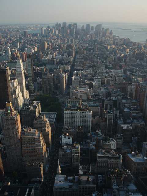 An aerial view shows a densely populated urban area with many tall buildings and skyscrapers.