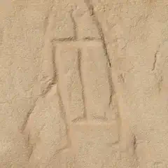 A beige rock face featuring a rectangular, humanoid petroglyph.