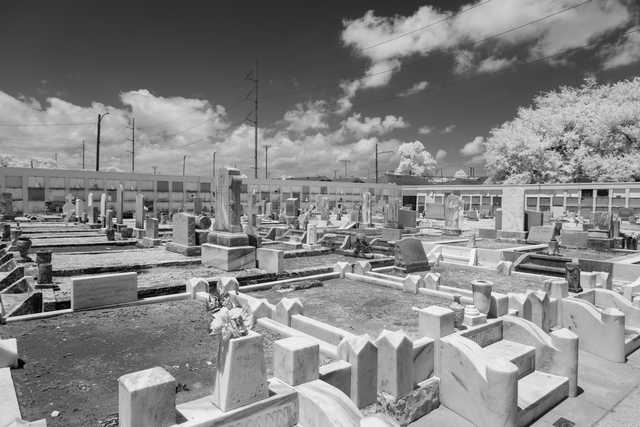 An old cemetery featuring multiple headstones and mausoleums.
