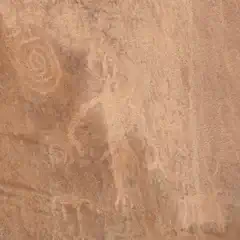 A brown stone surface features faint circular markings on its left side.