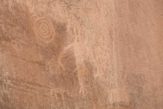 A brown stone surface features faint circular markings on its left side.