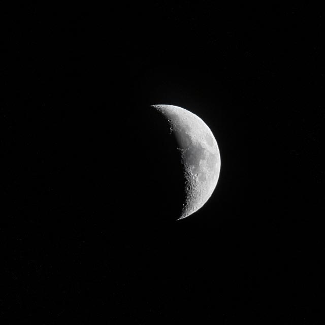 A half moon against dark sky.