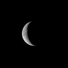 Crescent moon against a dark night sky.