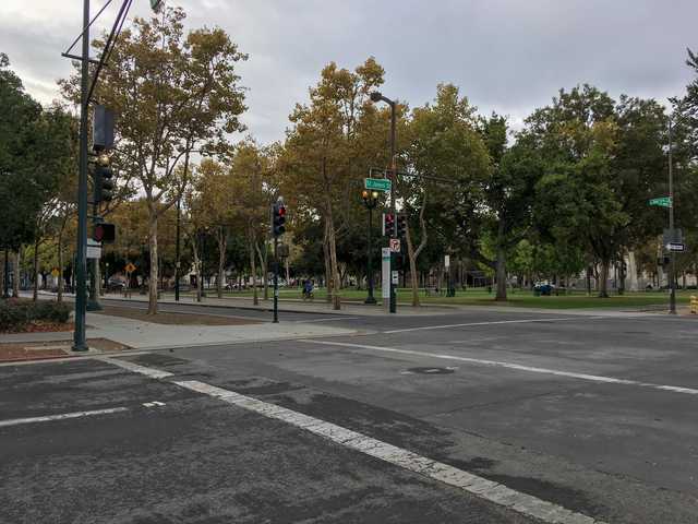 An intersection is visible, with a street sign reading 'St. James St.' and a park area beyond.