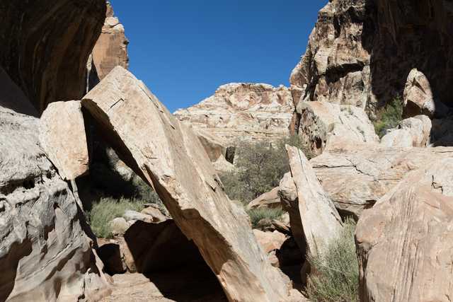 A rocky canyon under a blue sky.