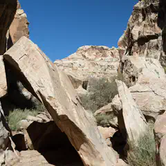 A rocky canyon under a blue sky.