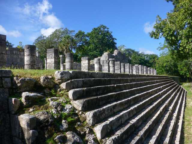 A wide stone staircase leads up to a row of columns.