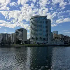 A lake lined with tall apartment buildings on its shores.