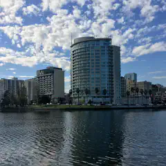 A lake lined with tall apartment buildings on its shores.