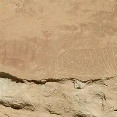 A rock wall with ancient petroglyphs and pictographs.