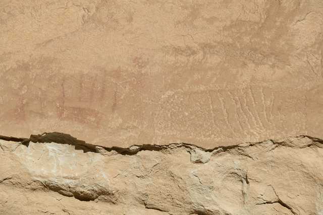 A rock wall with ancient petroglyphs and pictographs.