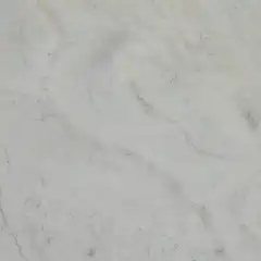 A close-up view of a marbled surface with light and dark veins running through it, giving an impression of natural stone.