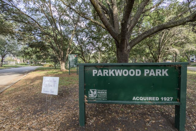 A green sign in front of a tree reads 'Parkwood Park'.