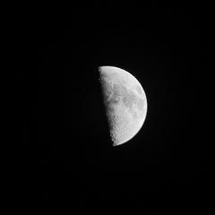 The moon is partially visible, showing its right half.