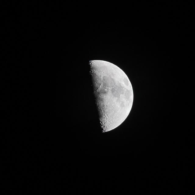 The moon is partially visible, showing its right half.