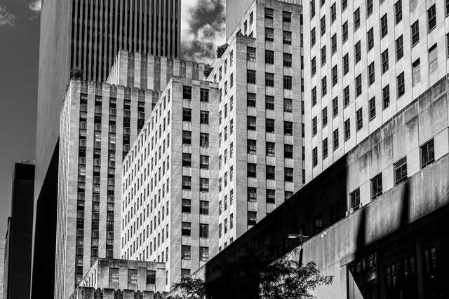 A group of tall buildings with numerous rectangular windows occupies the majority of the frame.