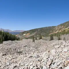 An expanse of gray rocks covers the foreground.