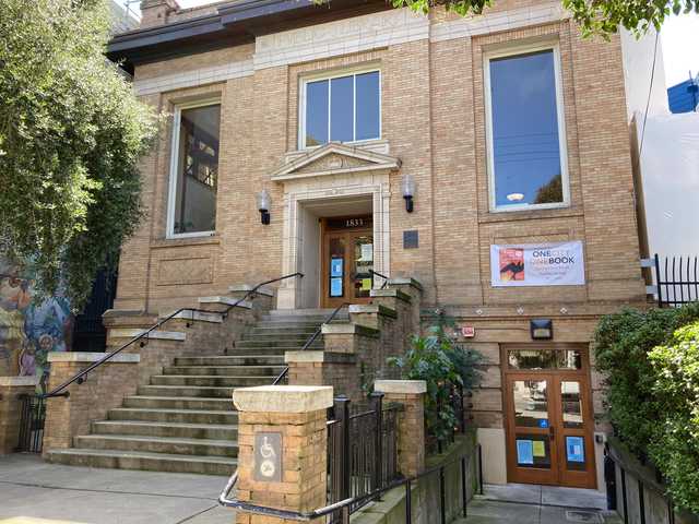 A brick building with a sign reading Public Library above the entrance.