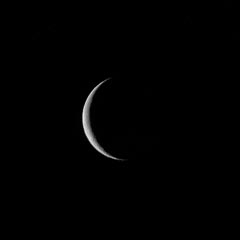 A crescent moon against a dark night sky.