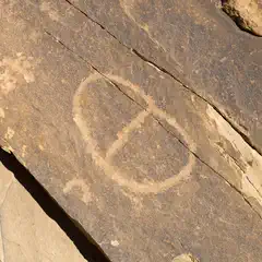 An oval shape is carved into a rock surface.