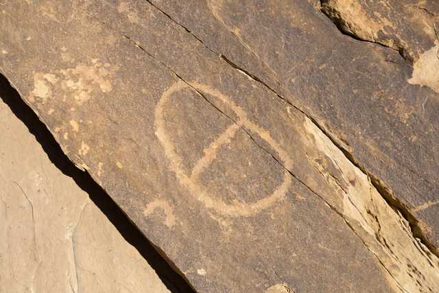 An oval shape is carved into a rock surface.