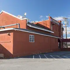 A red brick building with white trim has a sign reading 'Spice House' on its upper right corner.