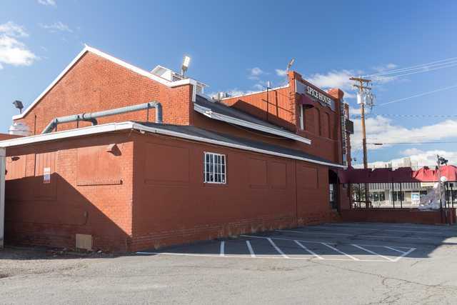 A red brick building with white trim has a sign reading 'Spice House' on its upper right corner.