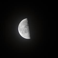 A half-moon is visible against a black background.