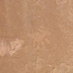 A flat, brown sandstone surface with a faint petroglyph of an antelope.