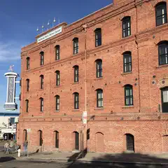 A red brick building with numerous windows is visible on a street corner.