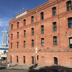 A red brick building with numerous windows is visible on a street corner.