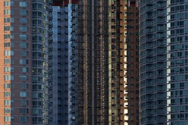 A cluster of high-rise buildings features repetitive window patterns and varying facade colors.