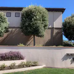 A sign reads Town of Colma Police in front of a beige building.