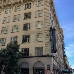 The Hotel Marker, a multi-story building with ornate architectural details, stands at a street corner under a clear blue sky.